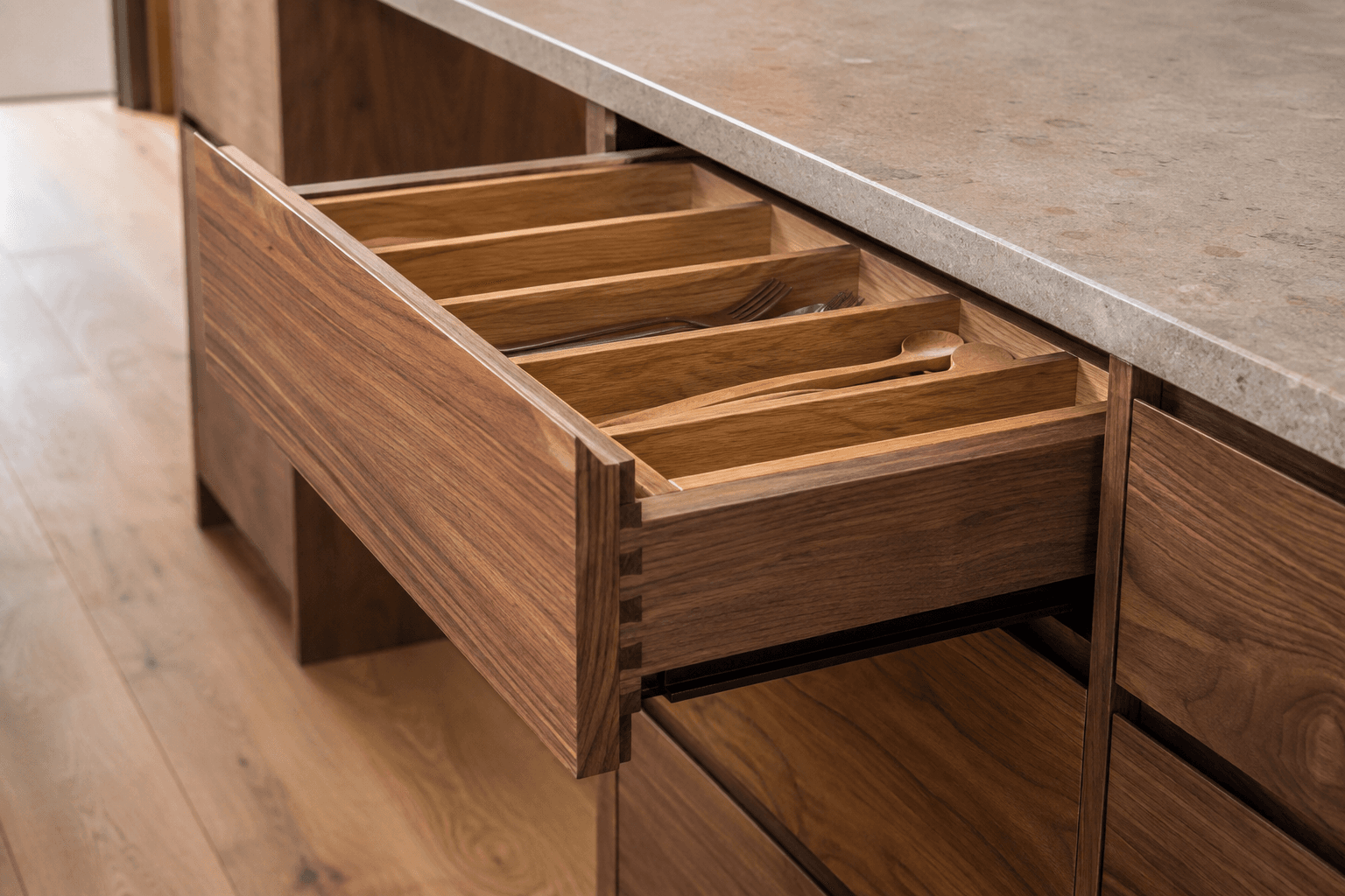 Walnut cabinet drawers showing internal storage compartments